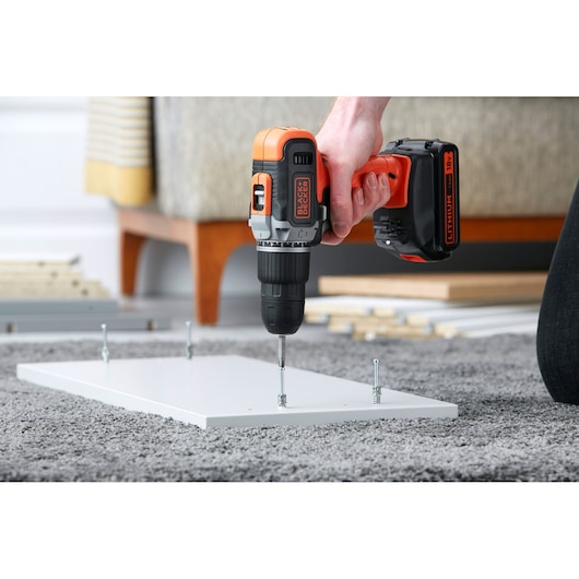 BLACKDECKER BCD003C1 cordless drill assembling white board on carpet.
