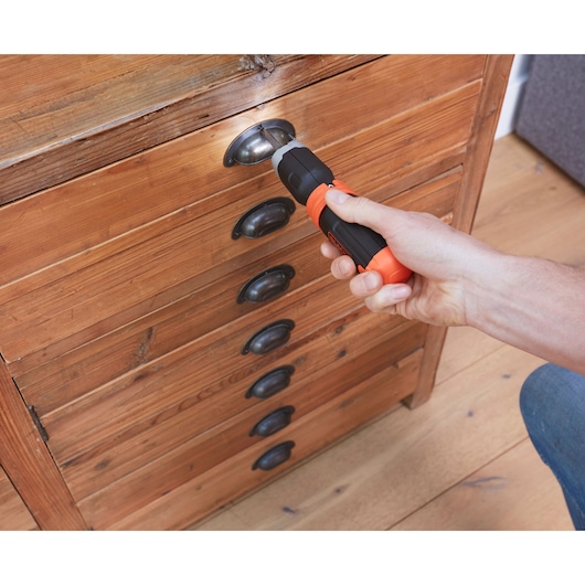 Photo of BLACKDECKER BCF601C cordless screwdriver being used on a drawer handle.