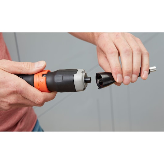 Photo of BLACKDECKER BCF601C cordless screwdriver being fitted with a black attachment, hands holding both pieces.