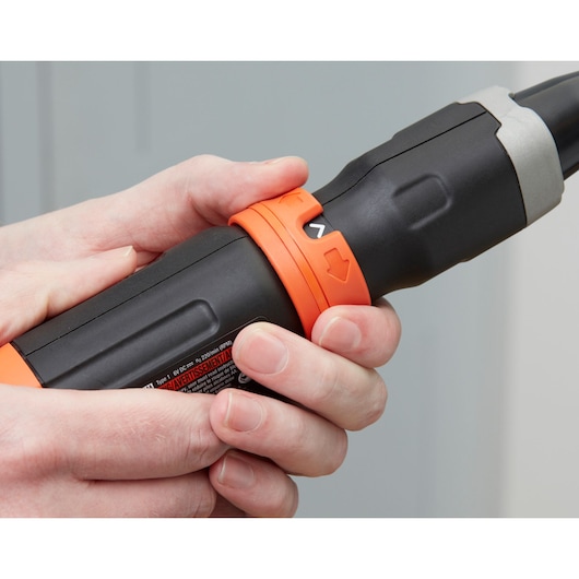 Close-up photo of BLACKDECKER BCF601C cordless screwdriver being held by hand, showing orange and black grip.