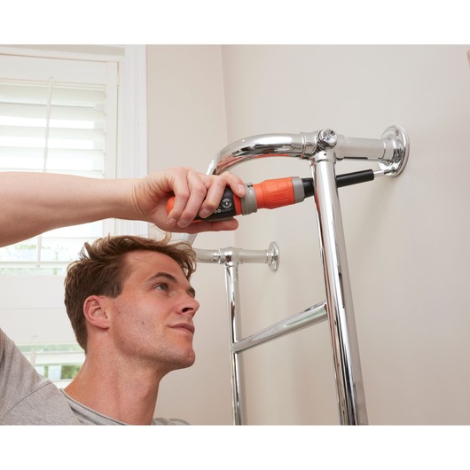BLACKDECKER BCF603C cordless screwdriver used to install chrome towel rack in bathroom.