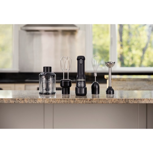BLACKDECKER BCKM1014KB black hand mixer set with attachments including beaters, whisk, chopper, and blending shaft on kitchen counter.