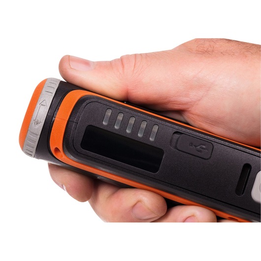 Close-up of BLACK+DECKER BCRT8I handheld tool with USB port and LED indicators, held in hand.