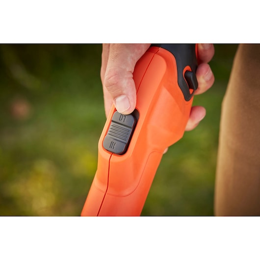 Close-up photography of BLACKDECKER BCSTA536L1 tool handle with speed control switch in use.