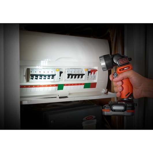 Photo of BLACKDECKER BDCK123S2S cordless worklight used to illuminate an electrical panel indoors.