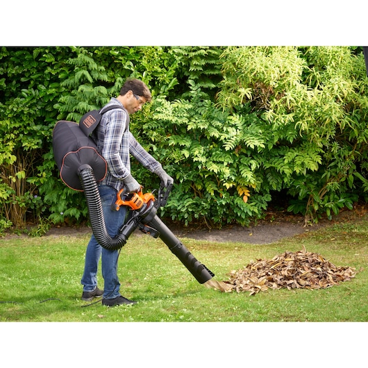 BLACKDECKER BEBLV301 leaf blower with backpack collecting leaves outdoors.