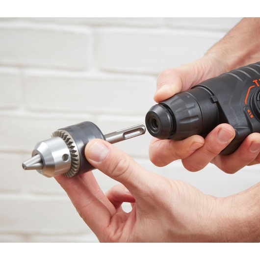 Photo of BLACKDECKER BEHS01K rotary hammer drill with keyless chuck attachment being installed, close-up view.