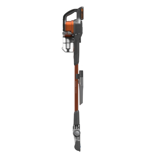 A BLACK+DECKER cordless stick vacuum cleaner, featuring an orange and grey design with a transparent dust container and a slim, upright profile.