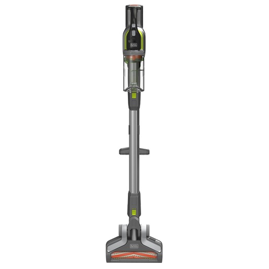 A BLACK+DECKER cordless stick vacuum cleaner with a grey body, orange detailing, a transparent dust container, and a wide floor head, shown upright against a white background.