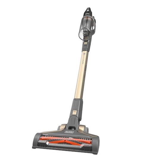 Cordless stick vacuum cleaner with a gold and gray design, featuring a transparent dust container and a wide cleaning head. The BLACK+DECKER branding is visible on the vacuum.