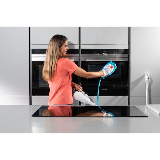 Photo of BLACKDECKER BHSM1615DSG steam cleaner being used to clean a kitchen oven door.