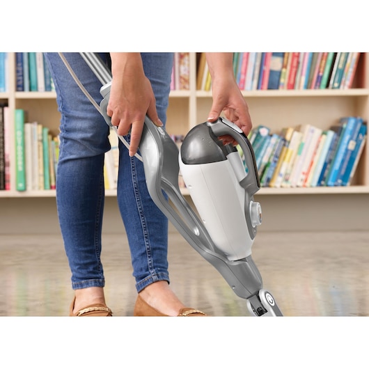 Photo of BLACKDECKER BHSM1615DSG steam mop being used on a hard floor, person’s hand detaching the handheld unit.