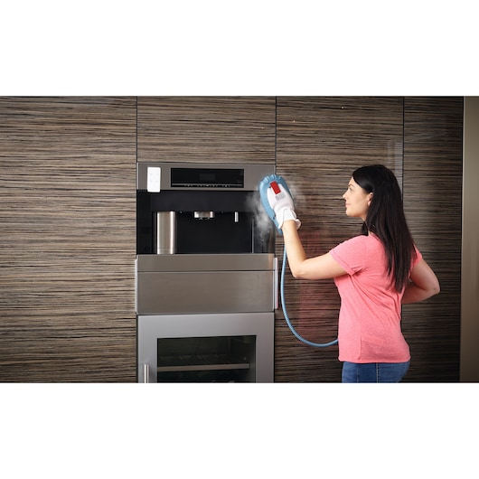 BLACKDECKER BHSM1615DSG steam cleaning glove in use cleaning built-in kitchen appliance.
