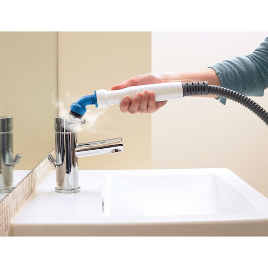 BLACKDECKER BHSM1615DSM steam cleaning tool used on bathroom faucet, close-up angle.