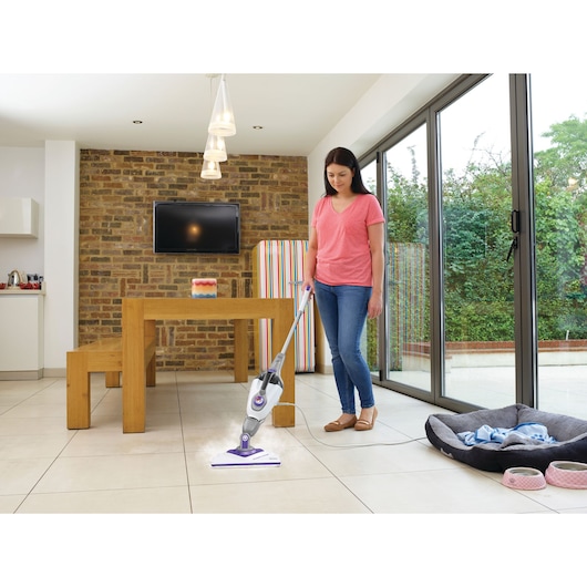 Photo of BLACKDECKER BHSM1615DSM steam mop cleaning tiled floor in modern kitchen.