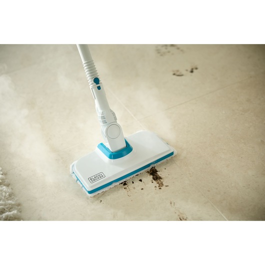 BLACKDECKER BHSMP2314 steam mop cleaning dirt from a beige tile floor, photography close-up.