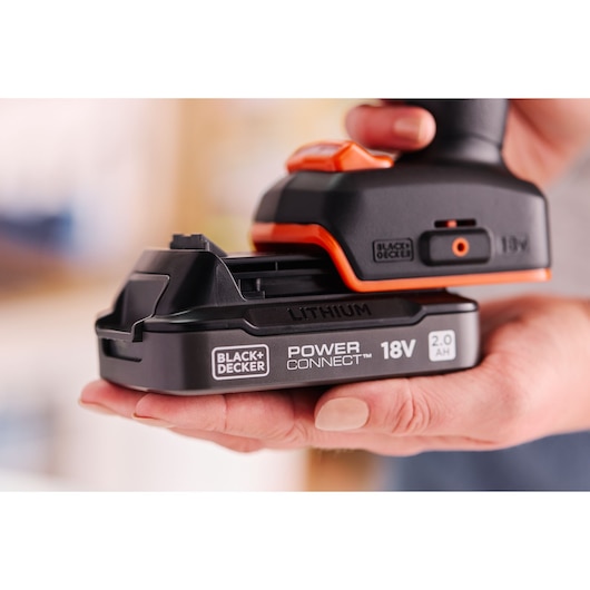 Photo of BLACK+DECKER 18V Power Connect lithium battery BLD682D1 held in a hand, close-up side angle.