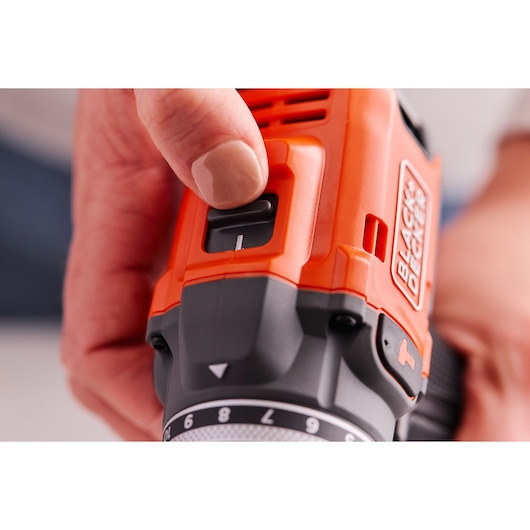 Close-up photo of BLACK+DECKER BLD683XN drill with hand adjusting speed switch, product details visible.
