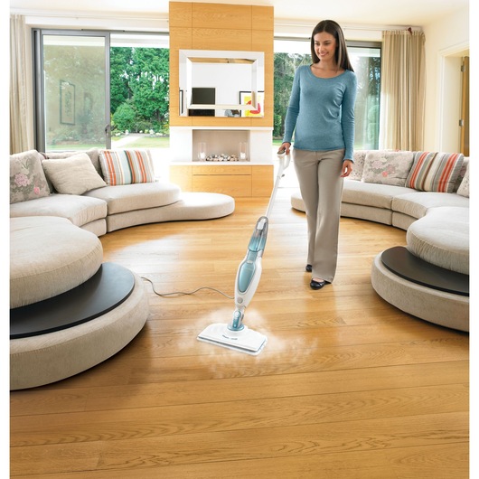 BLACKDECKER FSM16CD steam mop cleaning hardwood floor in modern living room, wide angle.