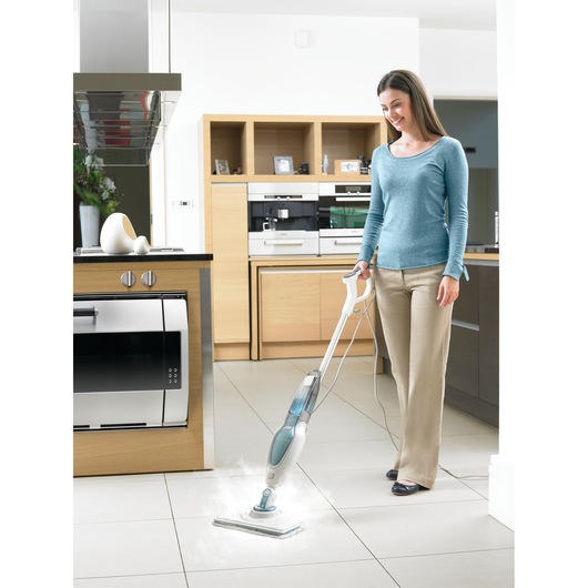 BLACKDECKER FSM16CD steam mop in use cleaning light-colored kitchen tile flooring.