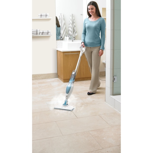 BLACKDECKER FSM16CD steam mop in bathroom cleaning light tile floor, held by a person.