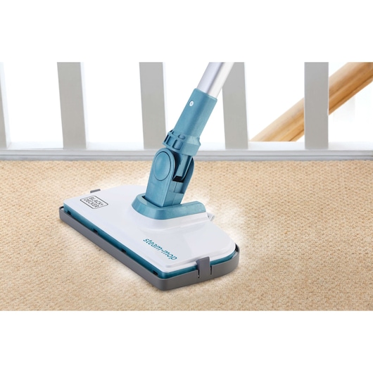 BLACKDECKER FSMH1300FX steam mop cleaning beige carpet, angled close-up view.