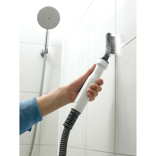 BLACKDECKER FSMH1321 steam cleaner tool cleaning shower tile grout, close-up angle.