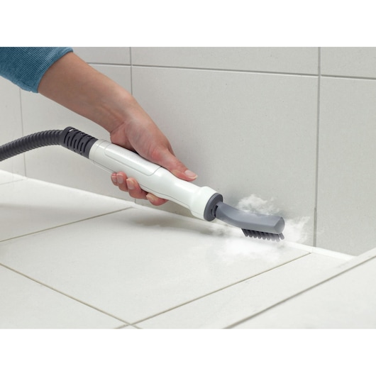 BLACKDECKER FSMH1321 steam cleaner handheld attachment cleaning tile grout, side angle.