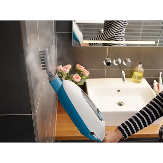 BLACKDECKER FSMH13E5 steam mop cleaning bathroom wall tiles near sink, diagonal angle.