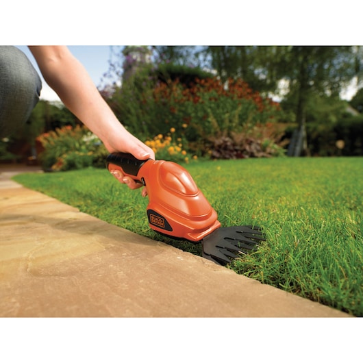 BLACKDECKER GSL200 cordless grass shear trimming lawn edge by hand in garden.
