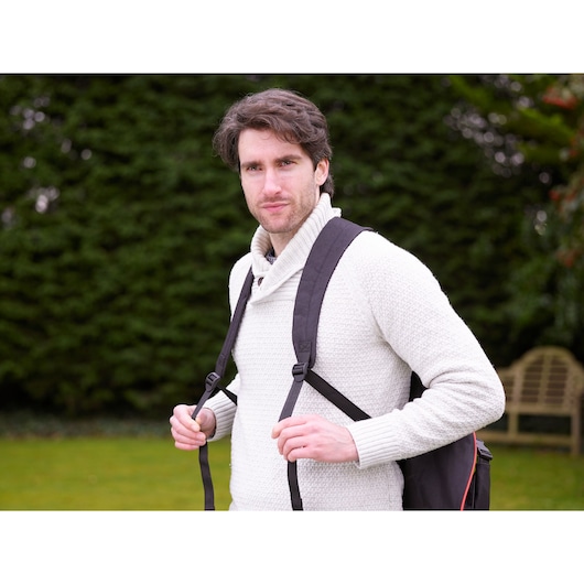 BLACKDECKER GWBP1 backpack with black straps outdoors, person wearing a white textured sweater.