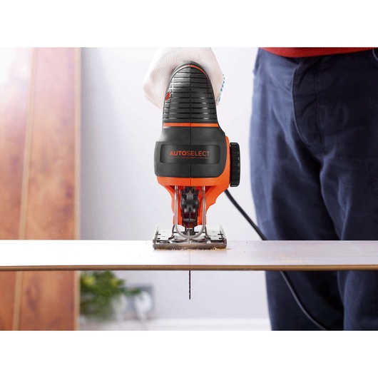 BLACKDECKER KS801SE jigsaw cutting wood, front view, glove holding the handle.