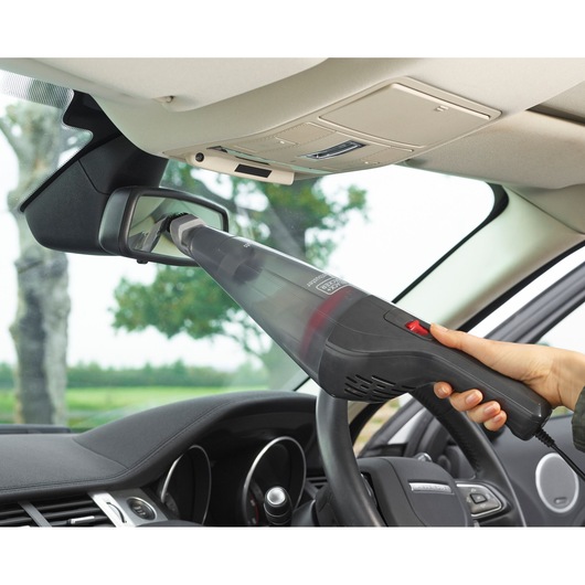 BLACK+DECKER NVB12AVA handheld vacuum cleaning car rearview mirror, close-up inside vehicle.