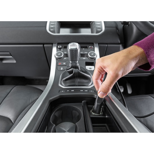 BLACKDECKER NVB12AVA car vacuum being plugged into car power outlet, close-up, SKU NVB12AVA.