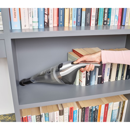 BLACKDECKER NVC220WC handheld vacuum cleaning bookshelf shelf, silver and black, side angle.