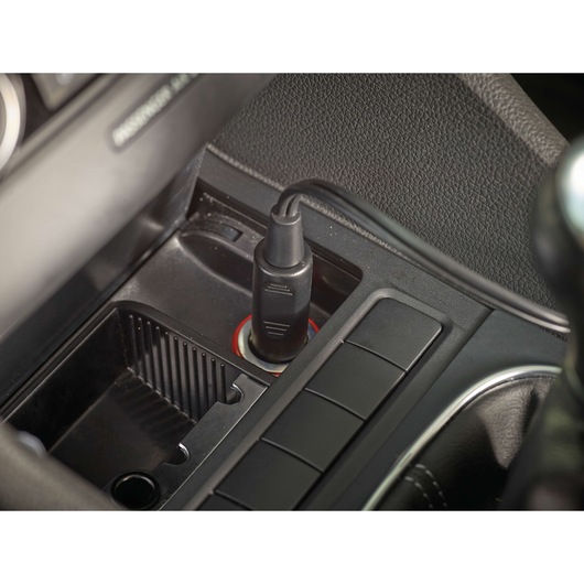 BLACK+DECKER PD1200AV car adapter plugged into a vehicle power outlet, close-up angle.