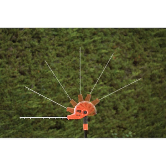 BLACKDECKER PH5551 hedge trimmer showing adjustable blade positions outdoors.