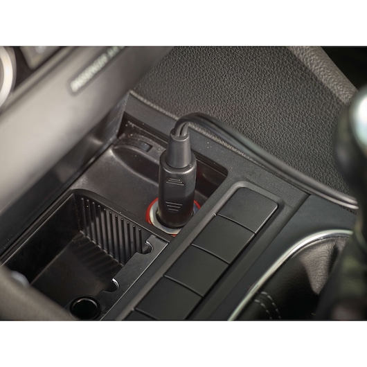 BLACKDECKER PV1200AV car charger plug inserted into vehicle outlet, close-up angle.